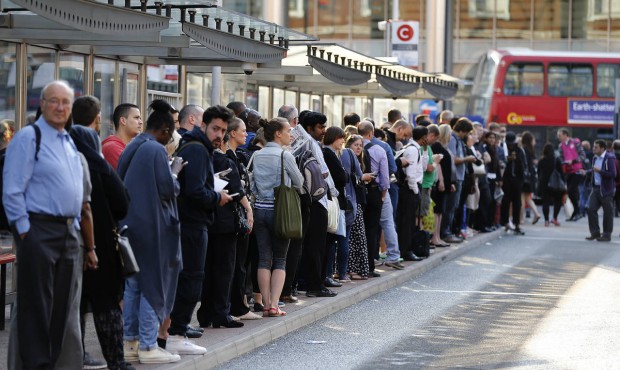 Commuters queue for buses as tube drivers are on strike in London, Thursday, July 9, 2015. Drivers ...