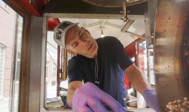 In this June 19, 2015 photo, Mark Flannigan makes a batch of popcorn at the Popcorn Wagon in Pittsf...