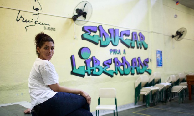 In this July 8, 2015 photo, trangender inmate Estefanie Ferraz poses for a portrait next to a mural...