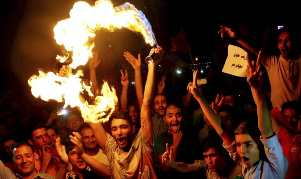 Iranians celebrate following a landmark nuclear deal in Tehran, Iran, Tuesday, July 14, 2015. Overc...