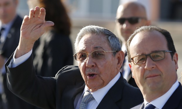 Cuba’s President Raul Castro waves to the press as he accompanies France’s President Fr...