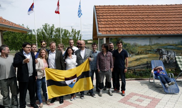 Vit Jedlicka, self-declared president of Liberland, fourth from left, poses with flag and supporter...
