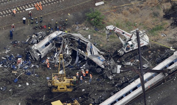 In this aerial photo taken May 13, 2015, emergency personnel work at the scene of a deadly train wr...