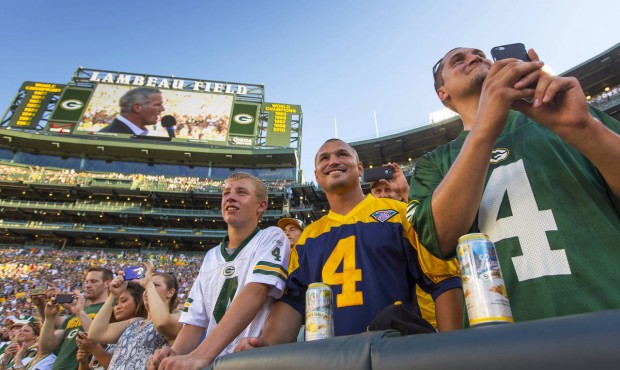 Fans watch former Green Bay Packers quarterback Brett Favre give a speech at Lambeau Field prior to...