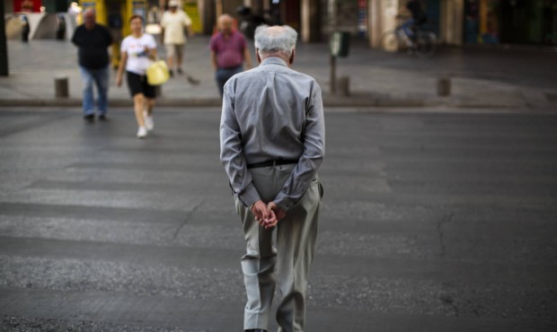 A man walks in central Athens, Monday, July 6, 2015. Greece’s finance minister has resigned f...