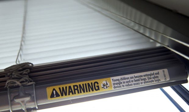 A label warns of strangulation risks from mini blind cords as seen on Wednesday, May 6, 2015, in Wa...