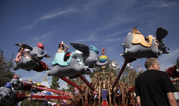 FILE – In this Jan. 22, 2015 file photo, visitors ride the Dumbo the Flying Elephant ride at ...