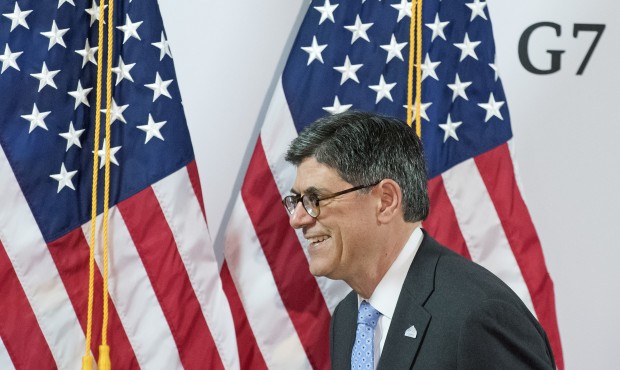 Jacob J. Lew, US Secretary of the Treasury, passes US flags after a press conference at the G7 Fina...