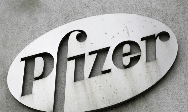 FILE – In this May 4, 2014, file photo, the Pfizer logo is displayed on the exterior of a for...