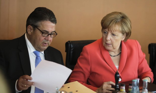 German Chancellor Angela Merkel, right, and Vice Chancellor and Economy Minister Sigmar Gabriel att...