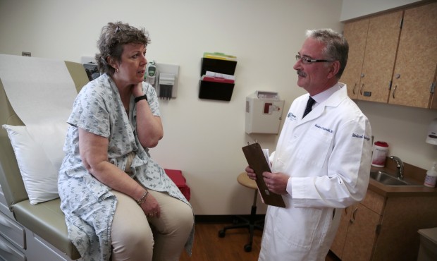 Patient Carole Linderman speaks to Dr. Massimo Cristofanilli before her blood is drawn for a liquid...