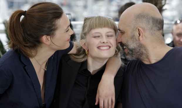 Actors Aomi Muyock, left, Klara Kristin, center, and director Gaspar Noe pose for photographers dur...