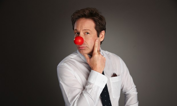 This April 2, 2015 photo released by NBC shows actor David Duchovny wearing a red clown nose to pro...