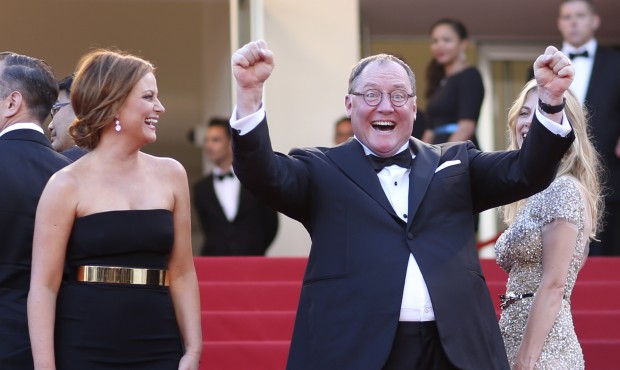 Actress Amy Poehler, left, laughs as chief creative officer at Pixar John Lasseter gestures for pho...
