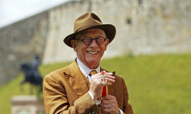 British actor John Hurt holds his award of a Knighthood presented by Britain’s Queen Elizabet...