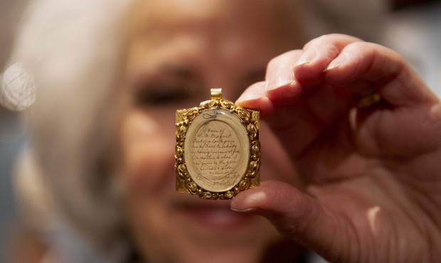 Gallery assistant Sandra Handley poses for photographs with a lock of Wolfgang Amadeus Mozart&#8217...
