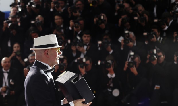 Director Jacques Audiard holds the Palme d’Or award for the film Dheepan as he poses for phot...