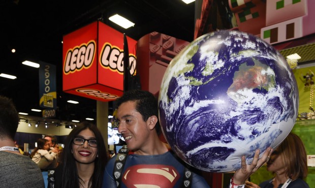 Bersain Gutierrez, dressed as Superman, and Belinda Sainz walk through the exhibit hall on Preview ...