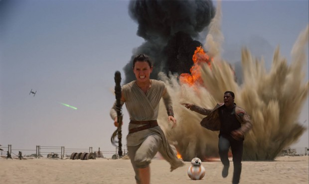 This photo provided by Disney shows Daisey Ridley as Rey, left, and John Boyega as Finn, in a scene...