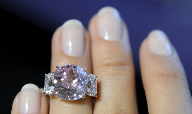 n A Sotheby’s employee shows ”the Historic Pink”, a ring with a fancy vivid pink ...