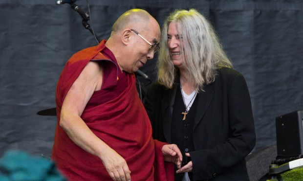 n Singer Patti Smith, right, and the Dalai Lama onstage at the Glastonbury music festival on Sunday...