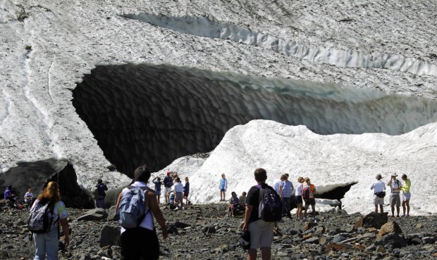 In this July 2010 photo, visitors examine the Big Four Ice Caves in the Mt. Baker-Snoqualmie Nation...