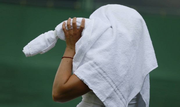 Anna-Lena Friedsam of Germany keeps cool under a towel during a break in a singles match Belinda Be...