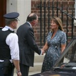 Carole Middleton, centre right, the mother of Kate, Duchess of Cambridge, meets Jonathan Ramsey, head of the Lindo Wing, as she arrives at St. Mary's Hospital exclusive Lindo Wing in London Tuesday July 23, 2013 where the Duchess gave birth to a son on Monday July 22. The Royal couple are expected to head to London's Kensington Palace from the hospital with their newly born son, the third in line to the British throne. (AP Photo/Alastair Grant)