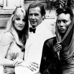 In this Aug. 17, 1984 file photo, actor Roger Moore, alias British secret agent James Bond, is seen with his co-stars Tanya Roberts, and Grace Jones, right, in front of Chateau de Chantilly, on the set of the 007 action film "A View to a Kill," near Paris, France. (AP Photo/Alexis Duclos, File)