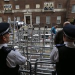 British police officers watch as stepladders are placed by members of the media outside St. Mary's Hospital exclusive Lindo Wing in London, Wednesday, July 3, 2013. The media are preparing for royal-mania as Britain's Duchess of Cambridge plans to give birth to the new third-in-line to the throne in mid-July, at the Lindo Wing. Cameras from all over the world are set to be jostling outside for an exclusive first glimpse of Britain's Prince William and the Duchess of Cambridge's first child. (AP Photo/Lefteris Pitarakis)