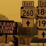 A sign asks for residents to evacuate as the Wallow Fire approaches in Springerville, Ariz., Wednesday, June 8, 2011. A raging forest fire in eastern Arizona has scorched an area the size of Phoenix, threatening thousands of residents and emptying towns as the flames raced toward New Mexico.(AP Photo/Marcio Jose Sanchez)