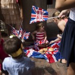 An impromptu picnic is had by a child an mother as supporters await the departure of Britain's Prince William, Kate, Duchess of Cambridge and the Prince of Cambridge, outside the entrance of the private Lindo Wing at St. Mary's Hospital in London, Tuesday, July 23, 2013. It's Day One of parenting for Prince William and Kate. After the excitement and fatigue and joy of childbirth, emotions shared with a nation, the young couple is expected to bring the prince home Tuesday. (AP Photo/Matt Dunham)