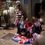 An impromptu picnic is had by children as supporters await the departure of Britain's Prince William, Kate, Duchess of Cambridge and the Prince of Cambridge, outside the entrance of the private Lindo Wing at St. Mary's Hospital in London, Tuesday, July 23, 2013. It's Day One of parenting for Prince William and Kate. After the excitement and fatigue and joy of childbirth, emotions shared with a nation, the young couple is expected to bring the prince home Tuesday. (AP Photo/Matt Dunham)