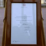 A notice proclaiming the birth of a baby boy to Prince William and Kate, Duchess of Cambridge is displayed for the public view at Buckingham Palace in London, Monday, July 22, 2013. (AP Photo/Sang Tan)