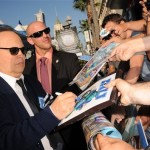 Billy Crystal signs autographs as he arrives at the world premiere of "Monsters University" at the El Capitan Theatre on Monday, June 17, 2013, in Los Angeles. (Photo by Jordan Strauss/Invision/AP)