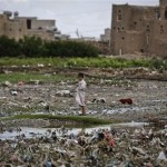 A Yemeni boy stands in the middle of garbage at a slum area on the outskirts of Sanaa, Yemen, Monday, April 22, 2013. Hundreds of countries globally, mark International Earth Day on April 22, to help raise ecological awareness and support environmental protection. (AP Photo/Hani Mohammed)