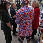 Royal supporter Terry Hutt, dressed in Union Jack dress talks to people as he waits across St. Mary's Hospital in London, Saturday, July 20, 2013. Media are preparing for royal-mania as Britain's Duchess of Cambridge plans to give birth to the new third-in-line to the throne in mid-July, at the Lindo Wing. Cameras from all over the world are set to be jostling outside for an exclusive first glimpse of Britain's Prince William and the Duchess of Cambridge's first child. (AP Photo/Lefteris Pitarakis)