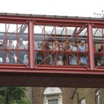 Medical staff and members of the public look out from a walkway above the road at media and people gathering outside an entrance of the private Lindo Wing at St. Mary's Hospital in London, where it is expected the couple will pose for the cameras with their baby when they leave, Tuesday, July 23, 2013. It's Day One of parenting for Prince William and Kate. After the excitement and fatigue and joy of childbirth, emotions shared with a nation, the young couple is expected to bring the prince home Tuesday.(AP Photo/Lefteris Pitarakis)